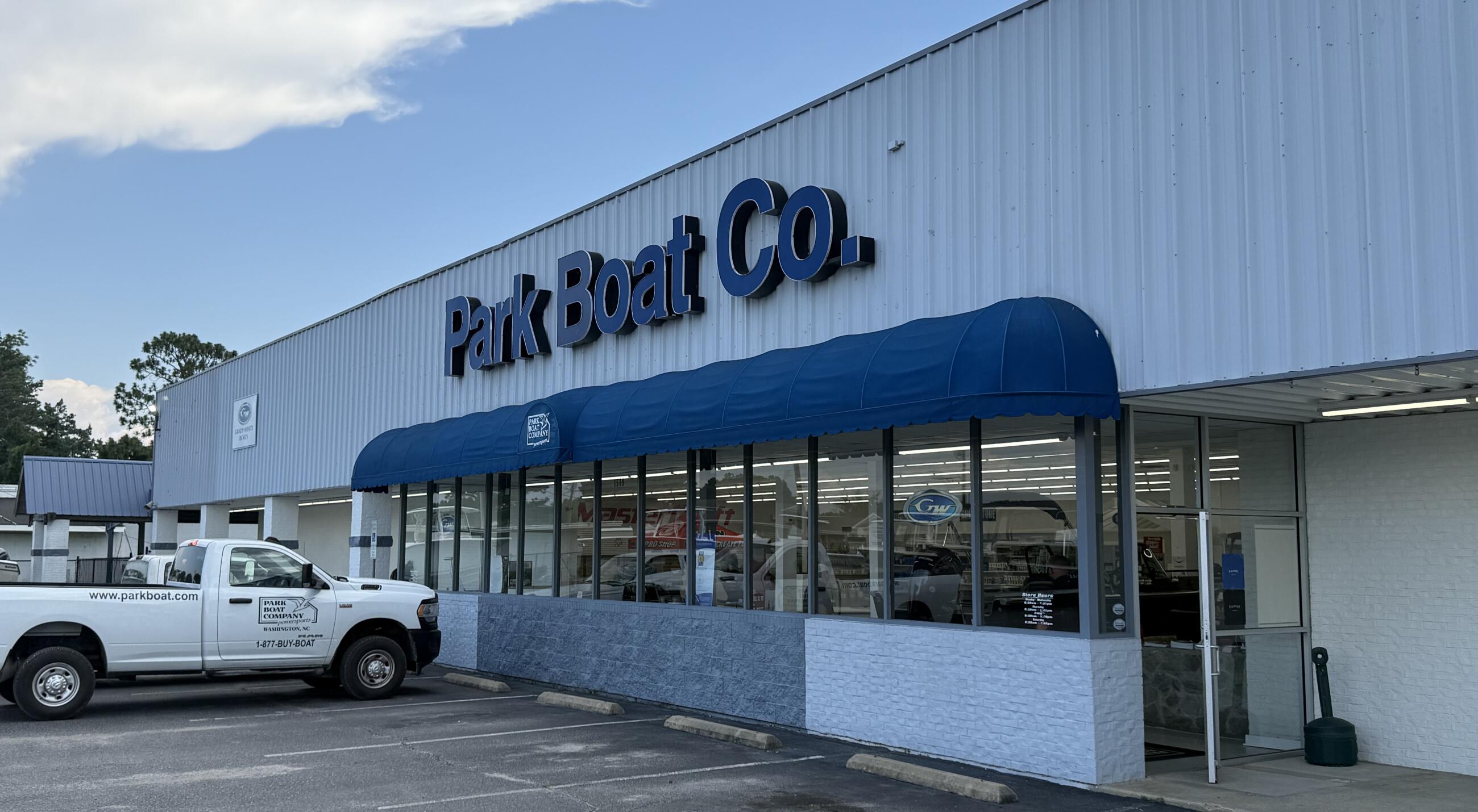 Park Boat Co. storefront with blue awning and white service truck parked outside