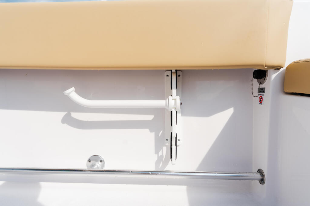 White interior cabin wall with mounted storage handles and ventilation system