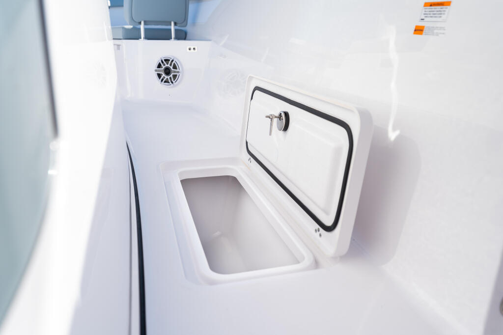 Open access storage compartment with white fiberglass construction and black-trimmed hatch door