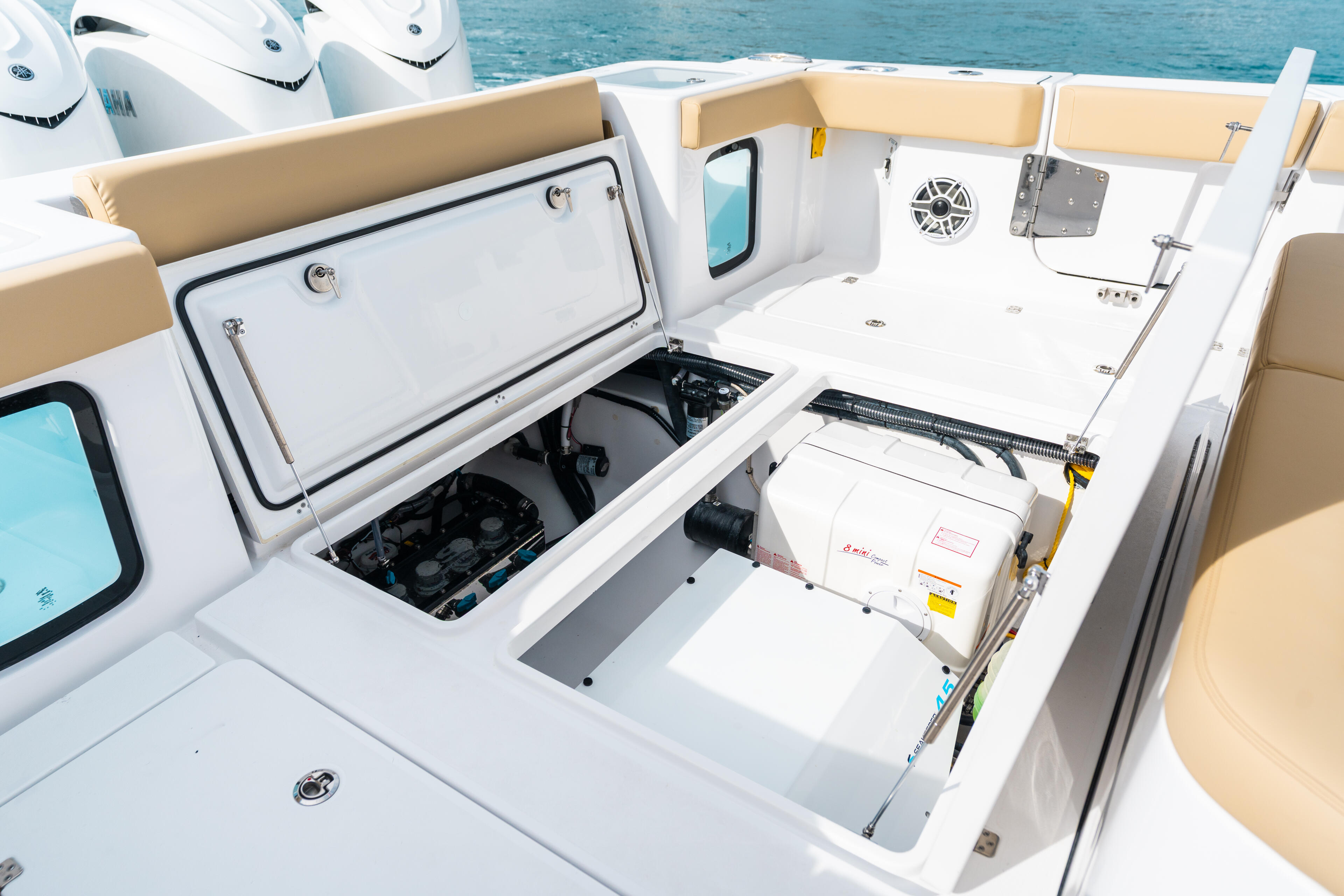 Open storage compartments with electronics and engine access on a center console fishing boat