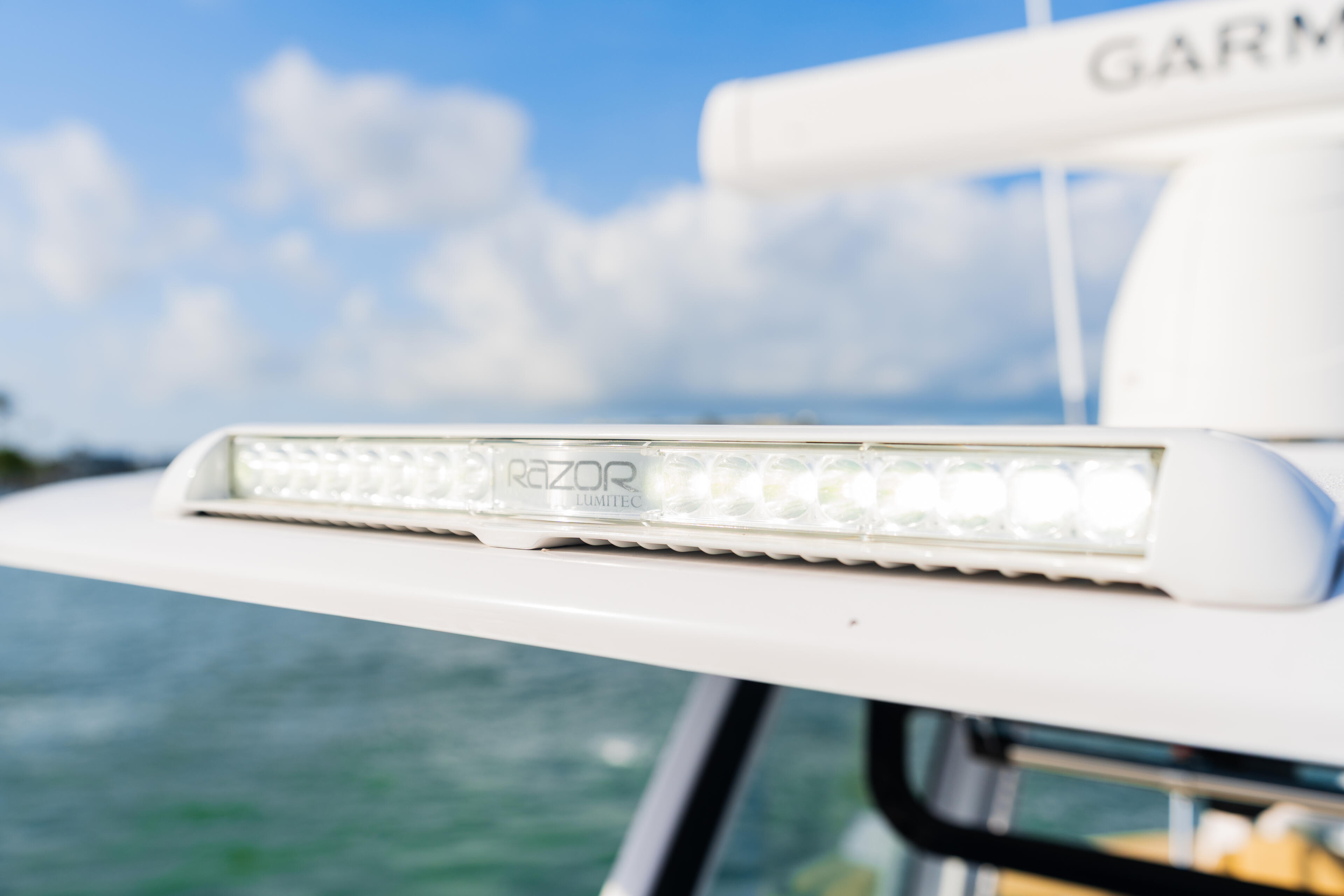 Razor LED light strip mounted on boat railing with water and sky in background