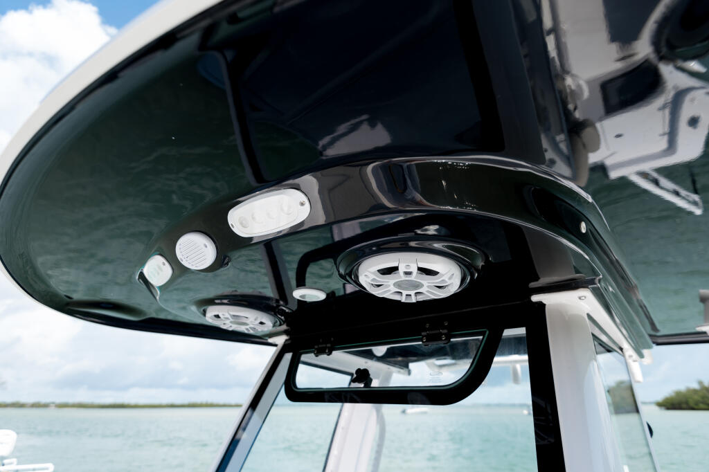 Hardtop with integrated spreader lights and gauges mounted above boat helm station