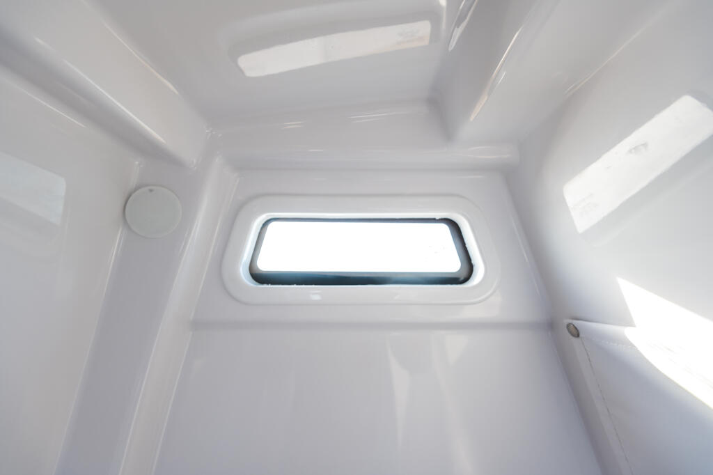Bright, clean cabin interior with large rectangular window providing natural light and visibility