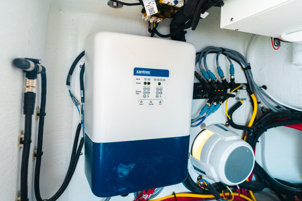 Xantrex battery charger mounted in boat cabin with electrical wiring and connectors
