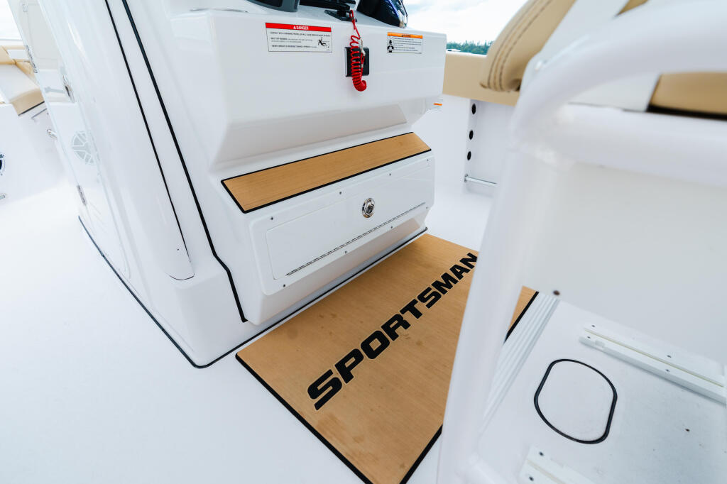 Sportsman boat cabin with white interior, wooden flooring, storage compartments, and safety equipment