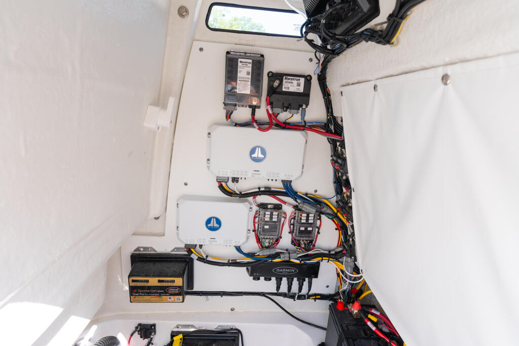 Electrical system components including batteries, breakers, and wiring installed in boat cabin