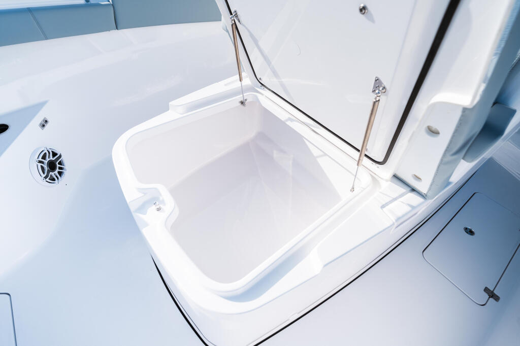 Open livewell box with drain plug on boat deck