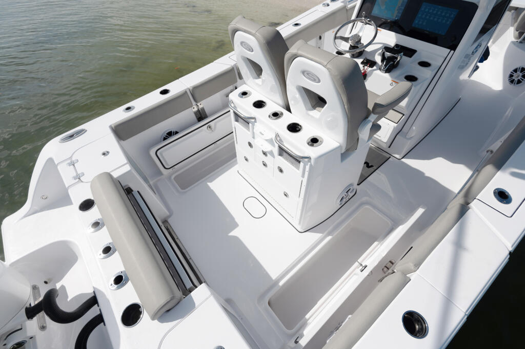 Center console fishing boat with dual helm seating, electronics, and in-deck fish storage boxes