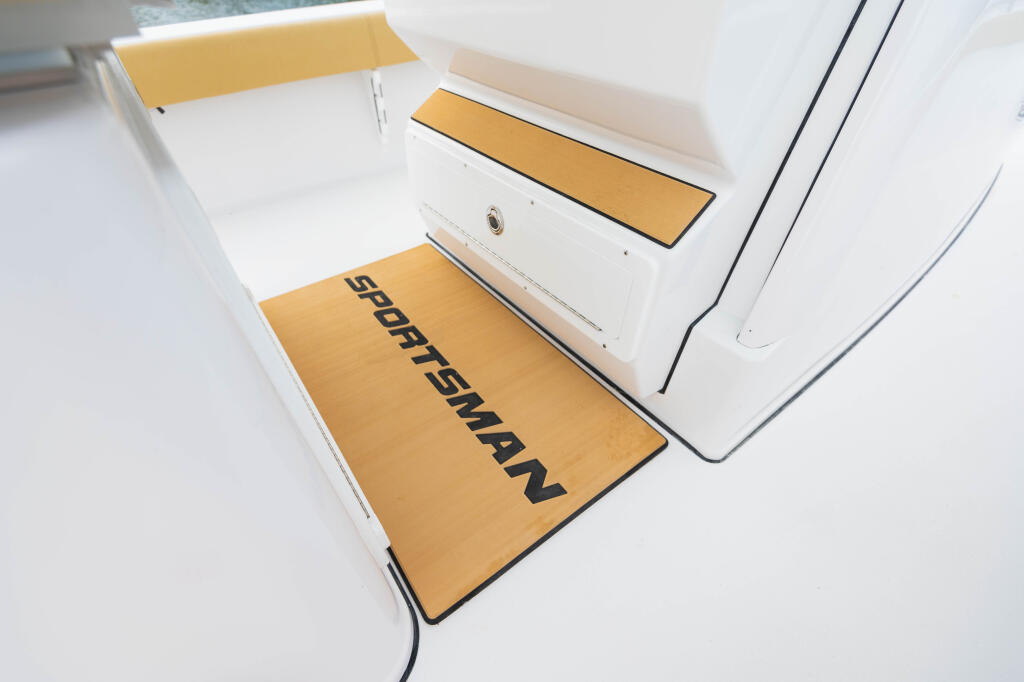 Anti-fatigue helm pad with gold surface and black text in boat cockpit area