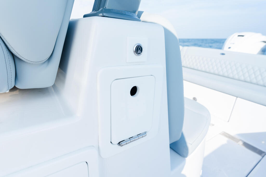 White fiberglass cabin pillar with electronics panel and control switches on a modern boat