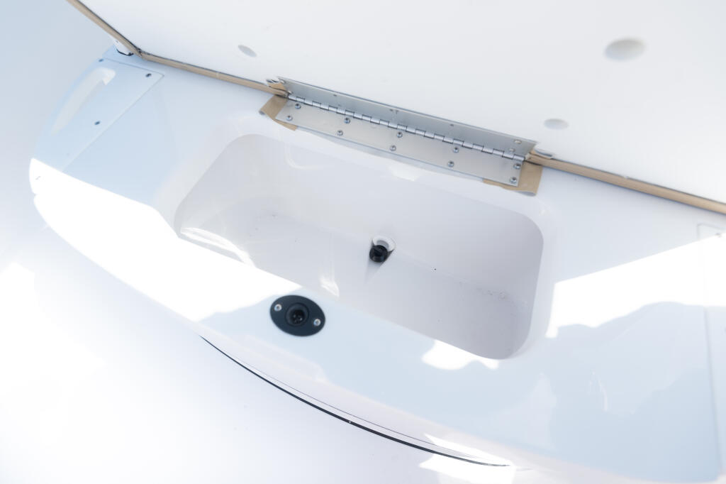 Center console cooler with integrated livewell and electronics mounted in the bow area