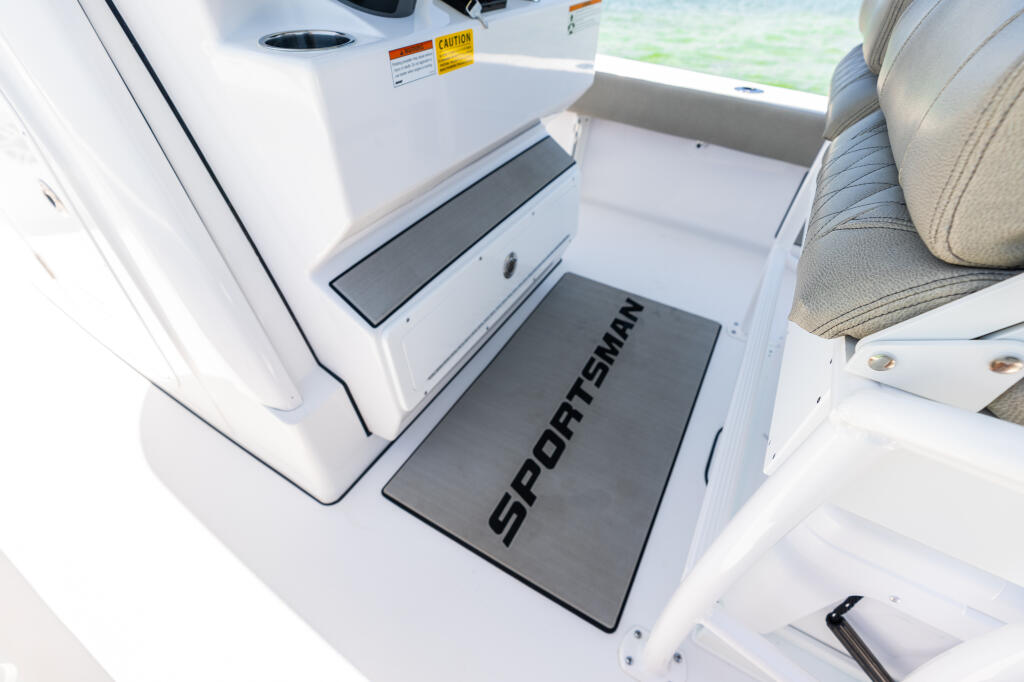 Sportsman anti-fatigue mat at helm station with white gelcoat and upholstered seating visible