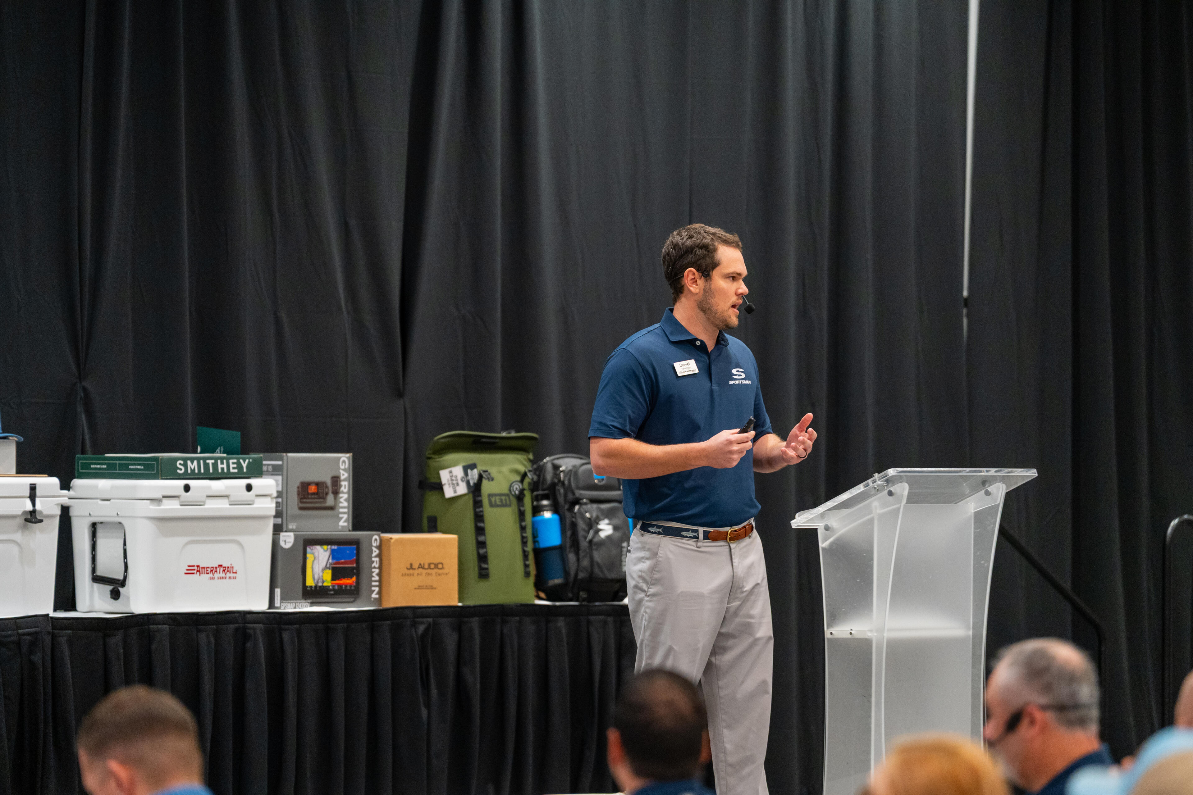Sales professional presenting boating equipment and electronics at an indoor training event