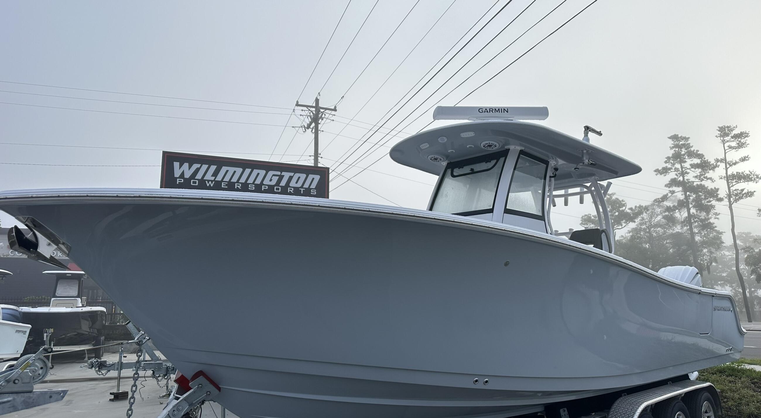Wilmington Powerboats center console fishing boat on trailer with Garmin electronics and hard-top canopy