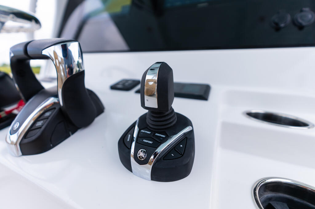 Yamaha autopilot and helm controls mounted on the center console of a boat dashboard