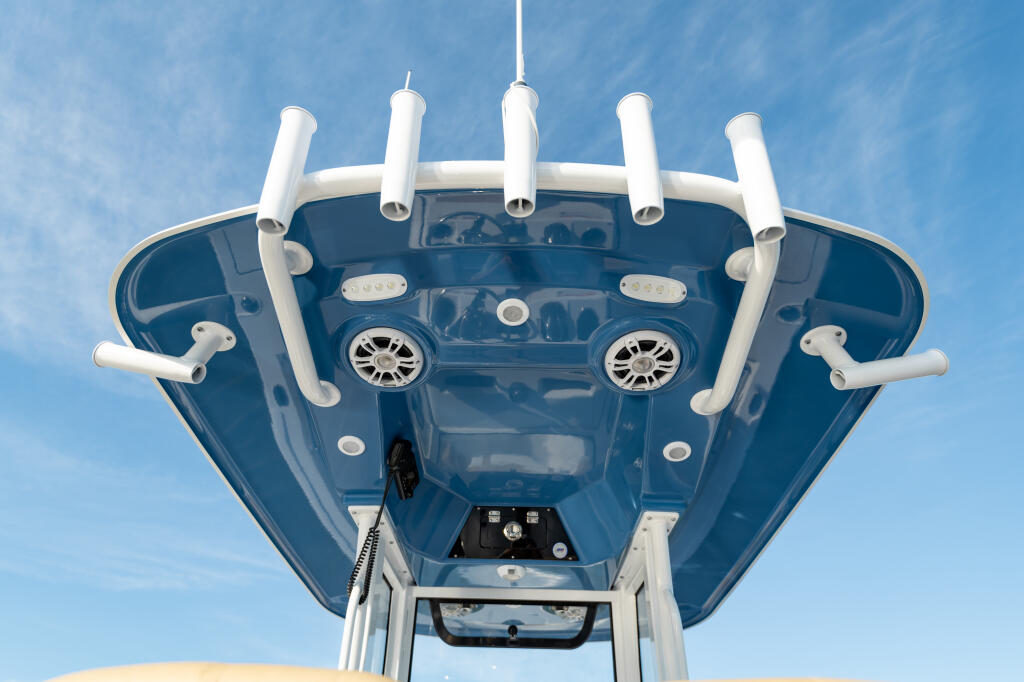 Overhead view of center console boat with twin engines, white hardtop frame, and electronics at helm