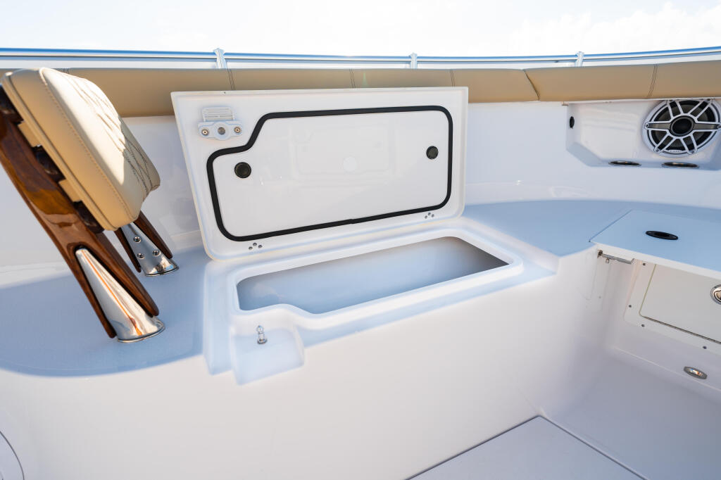 Open deck with livewell storage locker, cup holders, and electronics on a center console boat