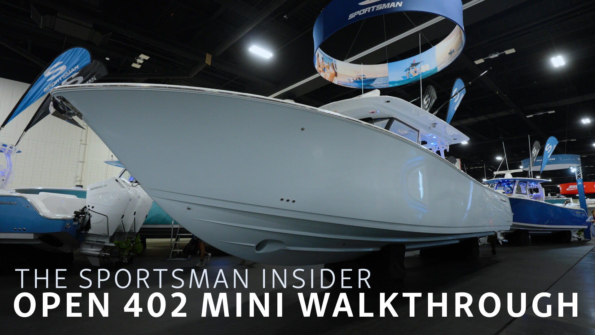 Sportsman Open 402 boat displayed at indoor marina or boat show with blue branding