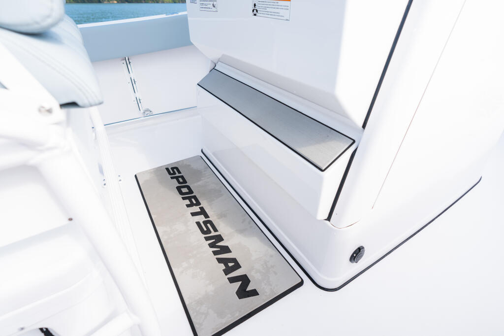 Sportsman-branded floor pad and storage compartment in a center console boat cabin area