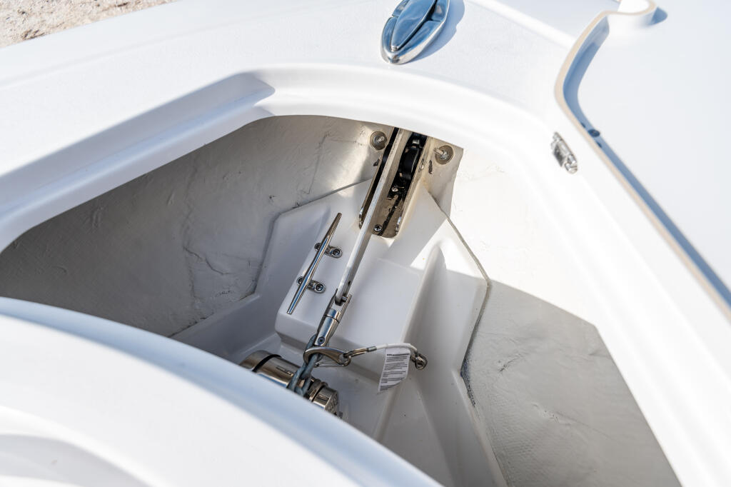 Boat's through-hull windlass and anchor control system mounted on center console with rope storage