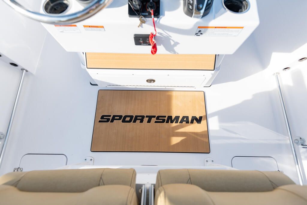 Overhead view of Sportsman boat cabin showing helm seating, hardtop shade structure, and control console