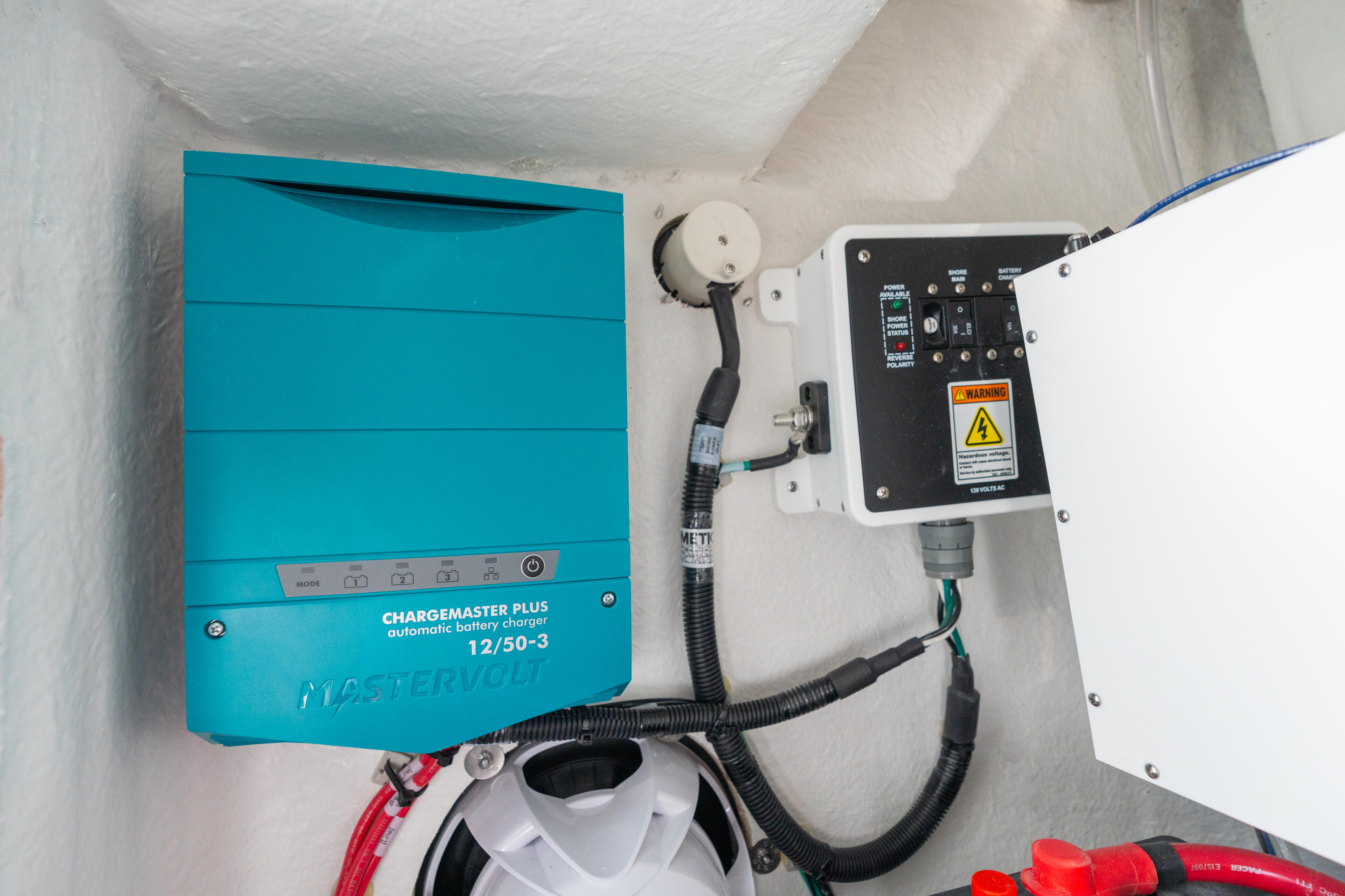MasterVolt Chargemaster Plus 12/50-3 battery charger installed in cabin with electrical panel and wiring