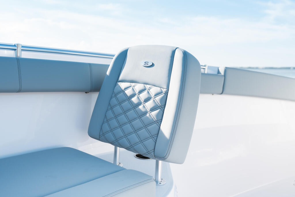 Blue and white quilted boat seat with branded logo on the back cushion