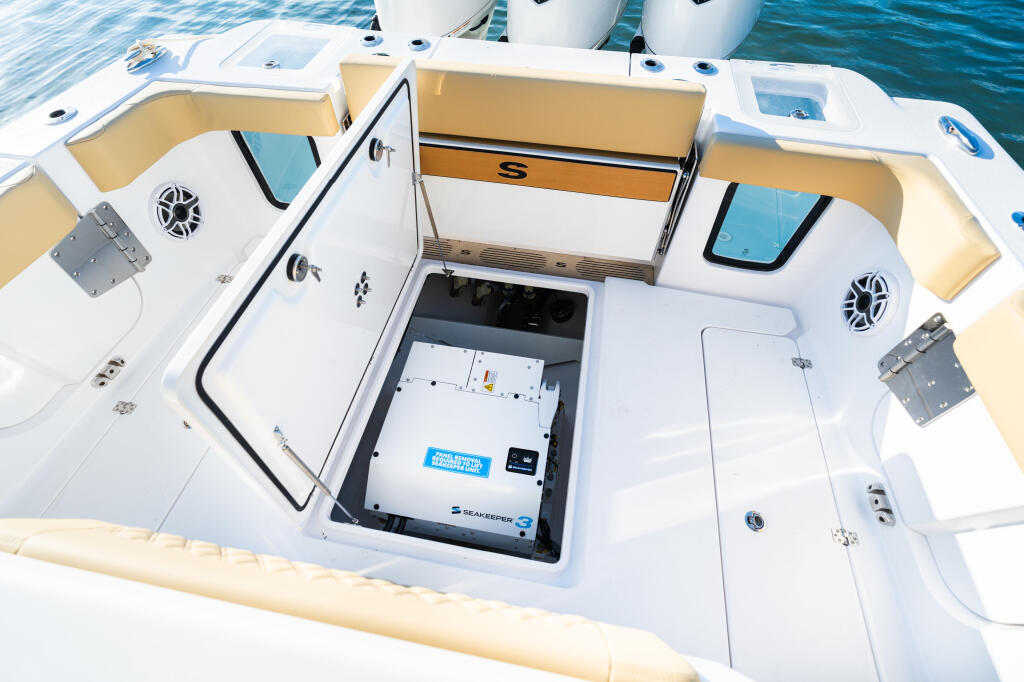Overhead view of boat cabin with open electrical panel and storage compartments