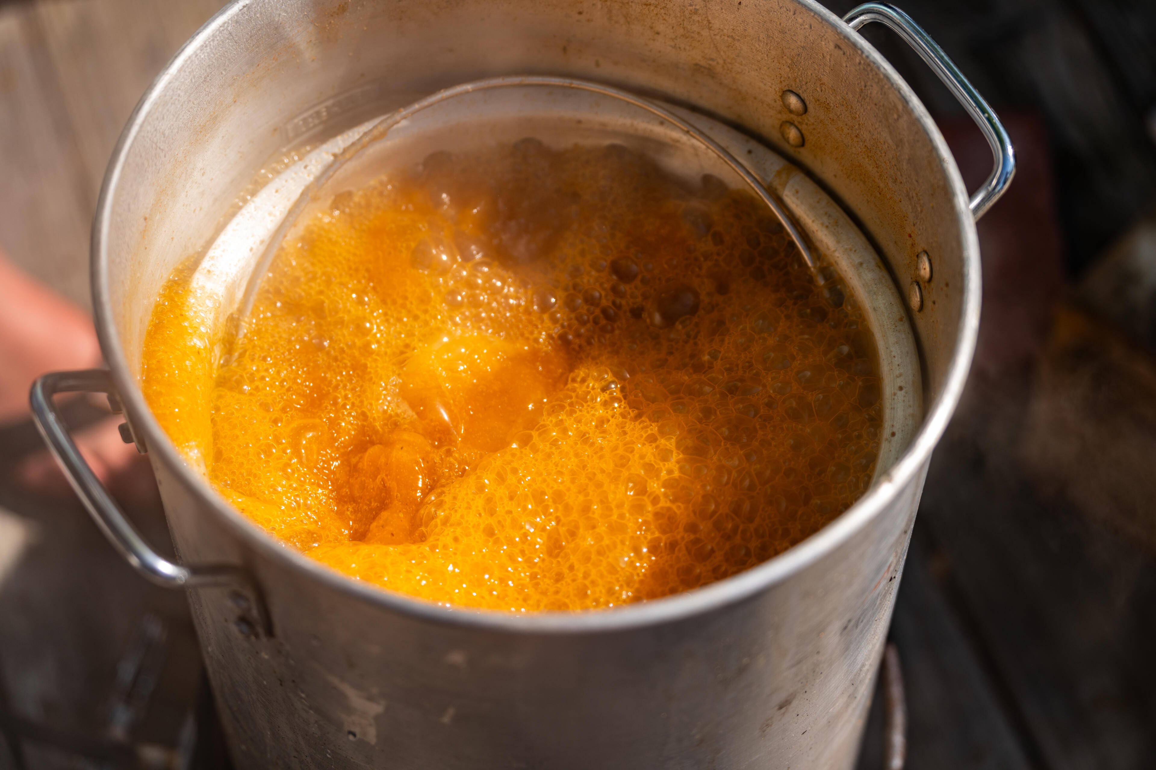Boiling pot of golden broth with seafood ingredients for lowcountry boil