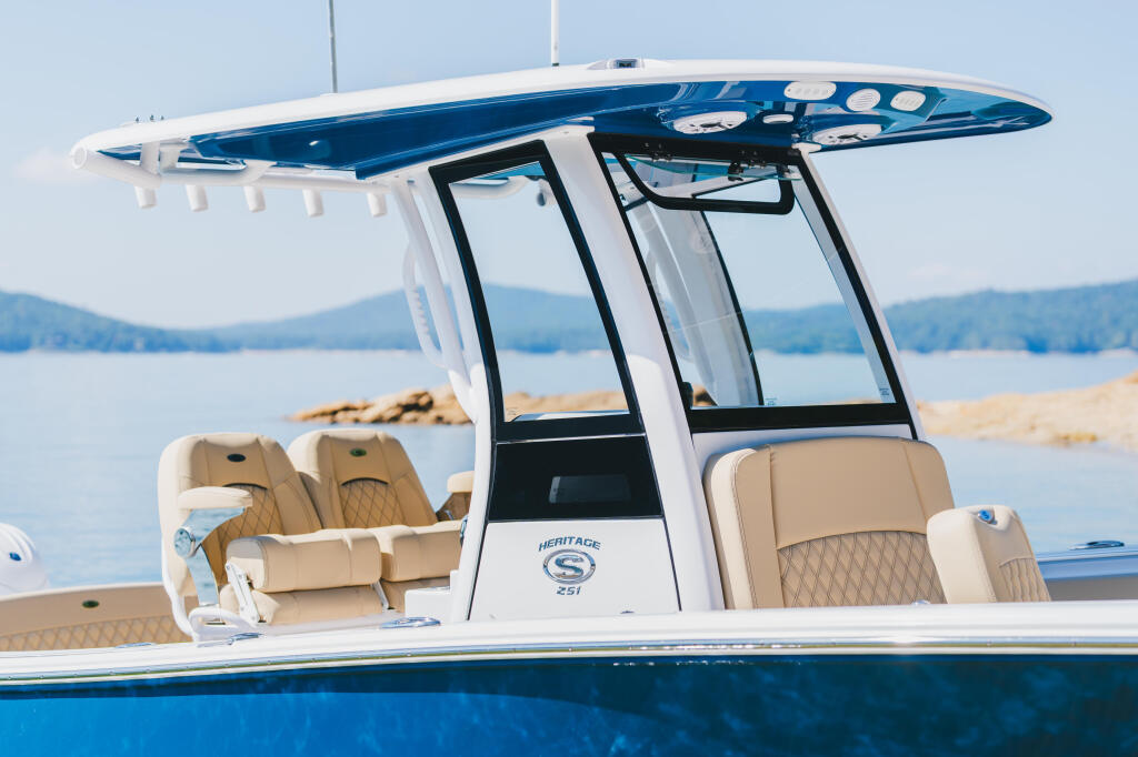 Heritage 251 center console boat with hard-top, tan seating, and blue hull docked at Lake Jocassee