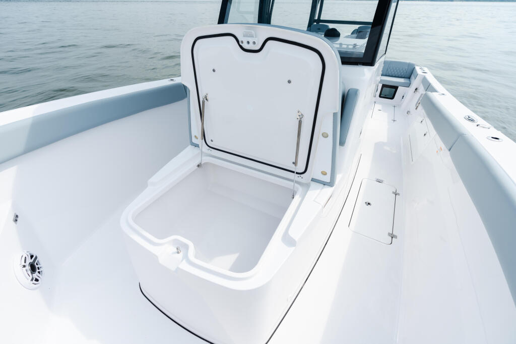 Open livewell with closed lid and spacious deck on a center console fishing boat