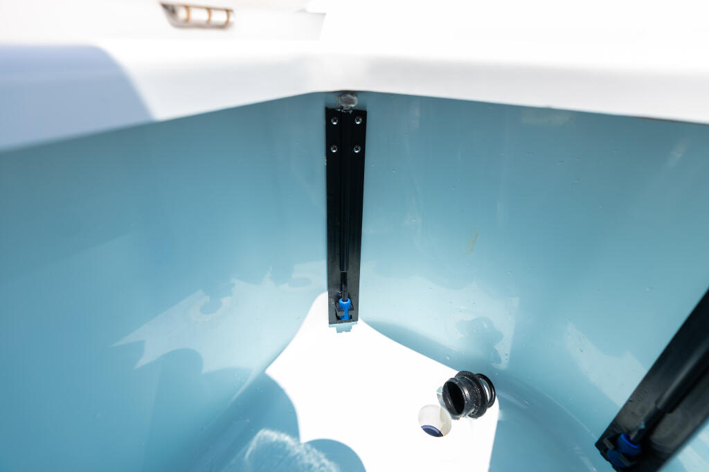 Close-up of boat's livewell drain and air system valve mounted on the gunwale