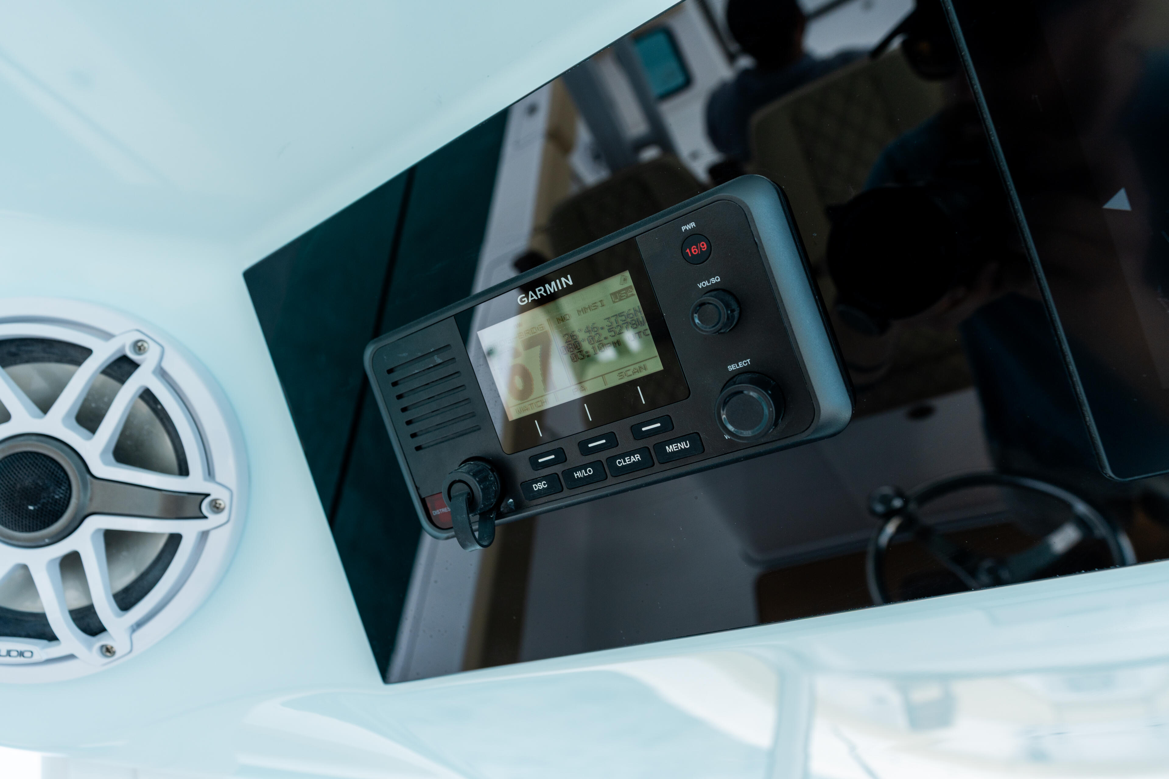 Garmin marine GPS chartplotter mounted on boat helm with sonar display and control buttons