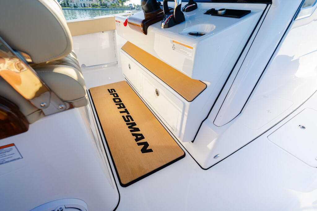 Teak-accented seating area and storage compartments on a Sportsman boat's open deck