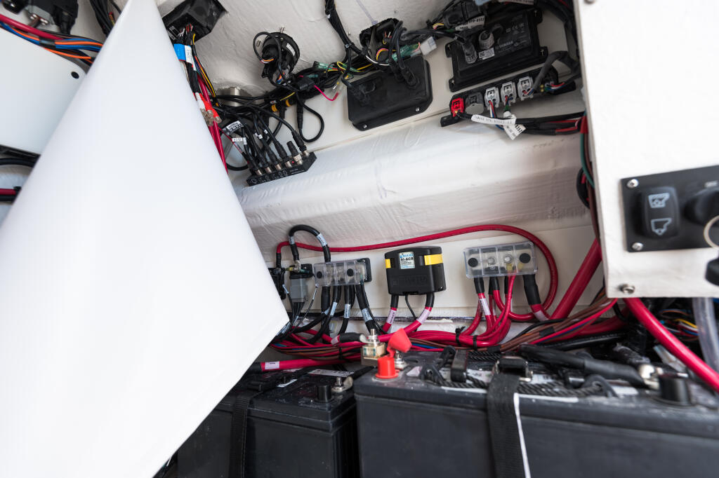 Boat electrical system with battery banks, fuses, relays, and color-coded wiring harness installed in engine compartment