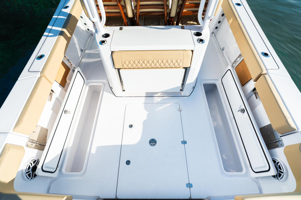 Overhead view of a center console fishing boat's open cockpit with tan seating and white gunwales