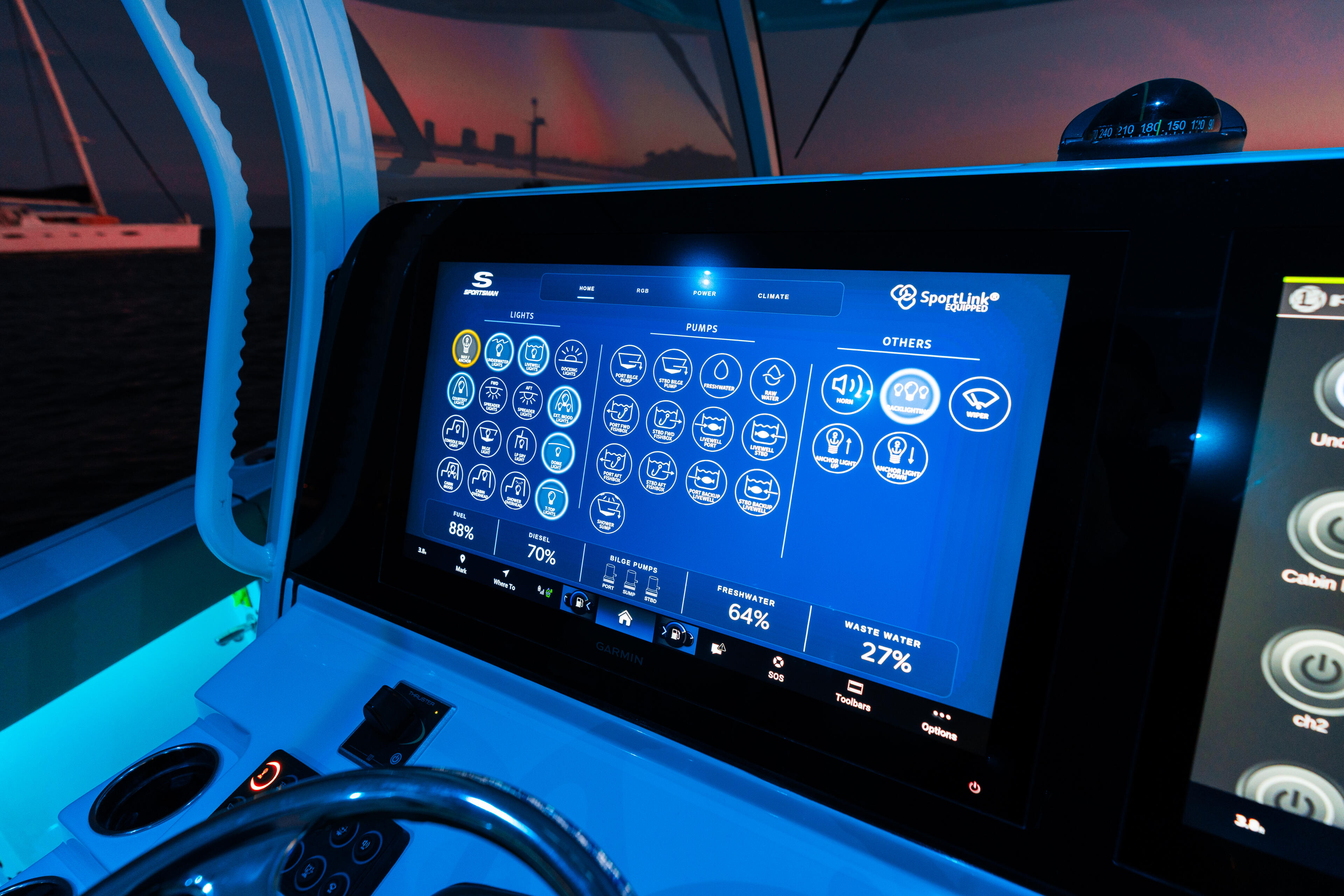 Helm display screen showing Sportlink system diagnostics and ambient blue LED lighting at sunset
