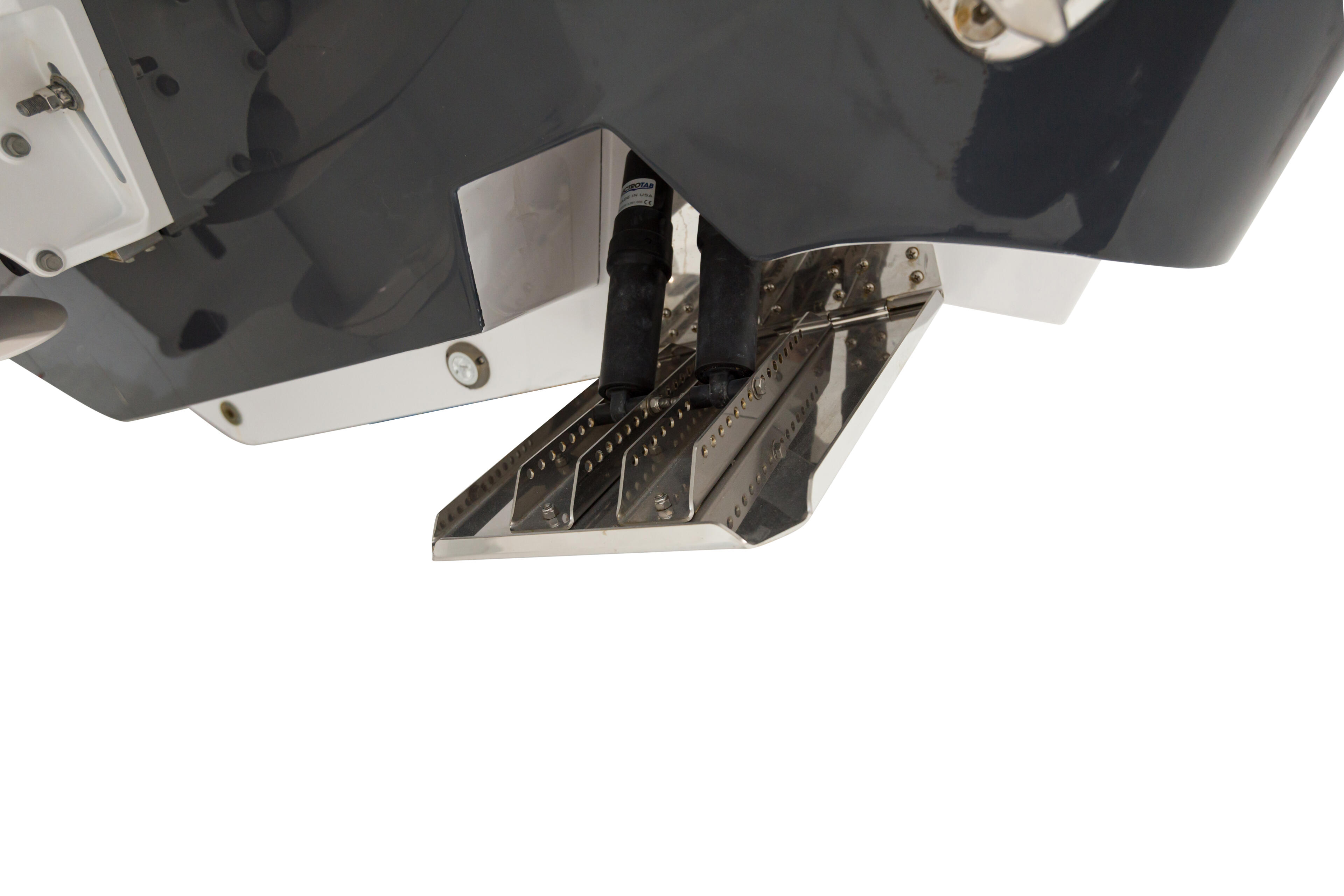 Overhead view of boat engine compartment with dual outboard motors and metal bracket hardware