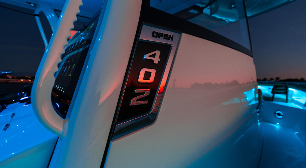 Center console boat 402 model with illuminated bow number and ambient RGB lighting at dusk