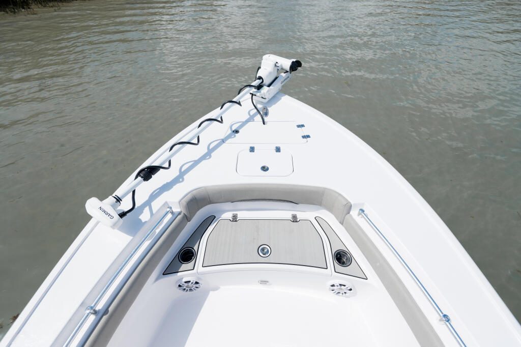 Wide bow casting deck with cleats and windshield on white center console boat
