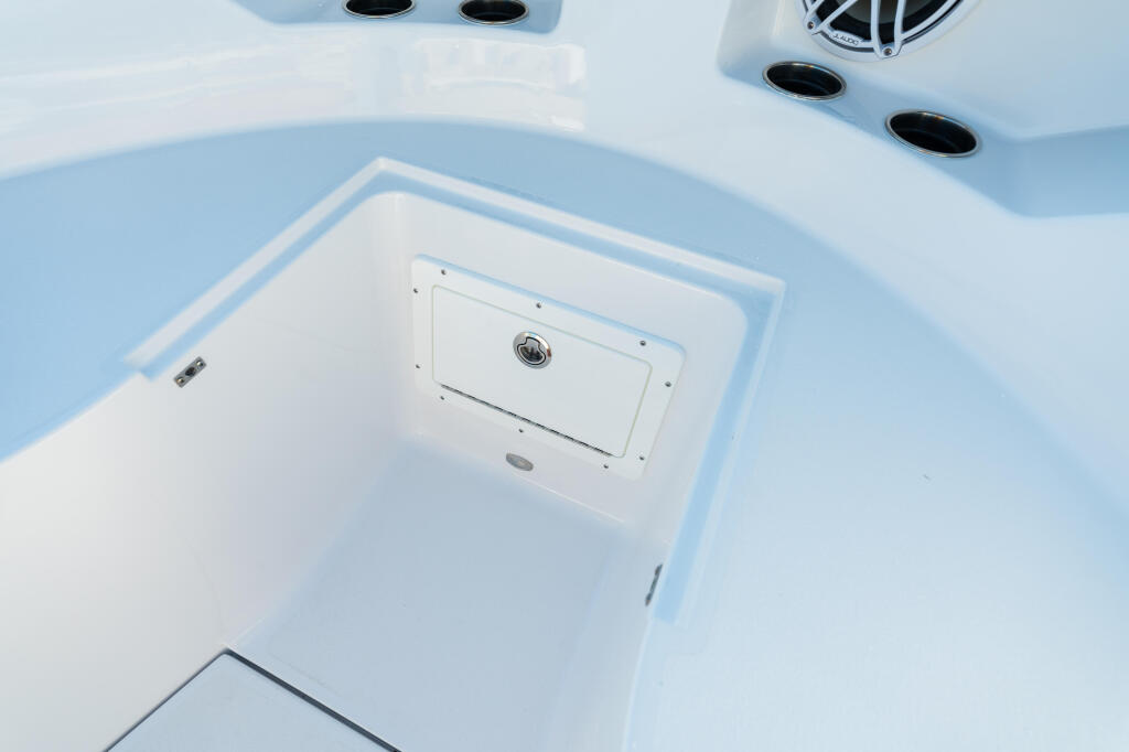 Overhead view of a boat's livewell storage compartment with white hatch cover and ventilation ports