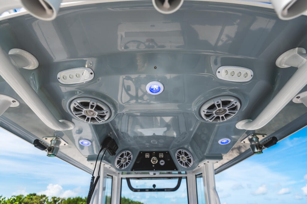 Hard-top ceiling view with dual speakers, LED lighting, and marine-grade electronics in white