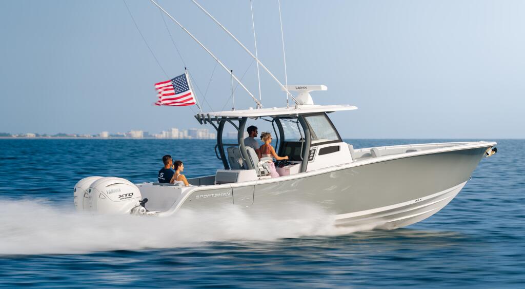 Couple relaxing in a white sport fishing boat with hard-top running through offshore waters with American flag flying