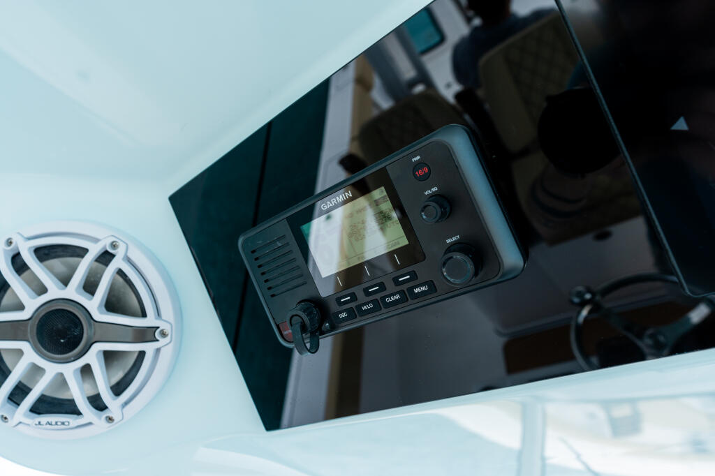 Garmin VHF 215 marine radio with GPS mounted at the helm, displaying navigation screen and control buttons