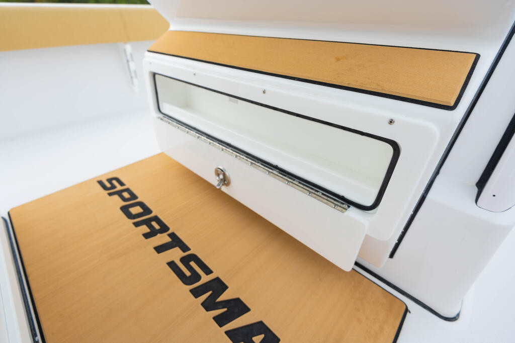 Helm pod storage compartment with tan cushioned seating and white interior cabinets marked 'SPORTSMAN'