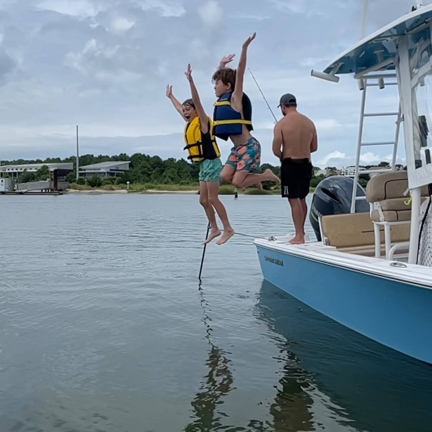 Title: Jumping at the sandbar - On board their Sportsman Masters 227 Bay Boat - Location: Lynnhaven Inlet, Virginia Beach. Participating in the Photo Contest #SportsmanSeptember2025
