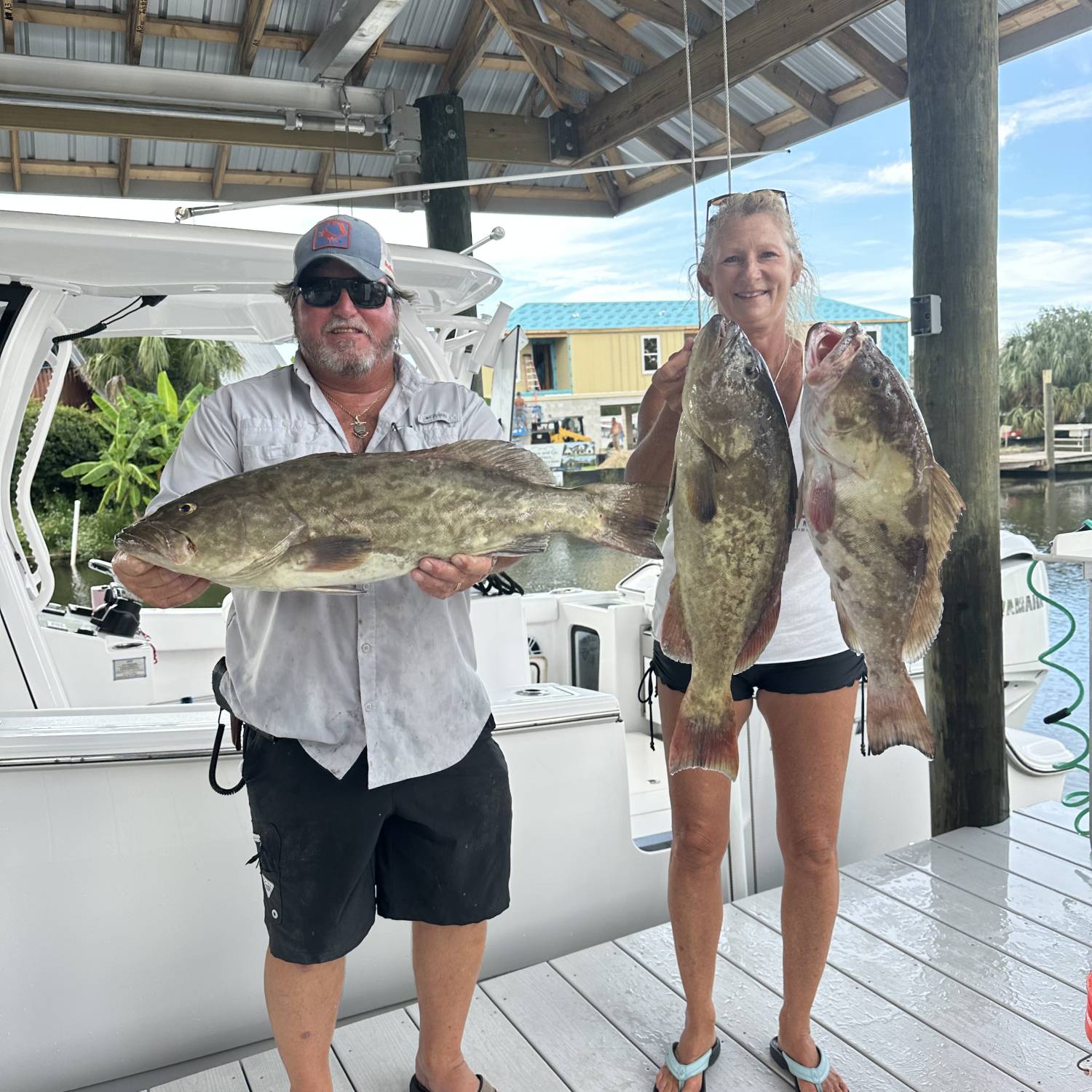 Me and my wife with a few grouper in front of my282 in its new house